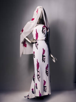 Dress and veil displayed on a mannequin featuring a pattern that looks like torn flesh